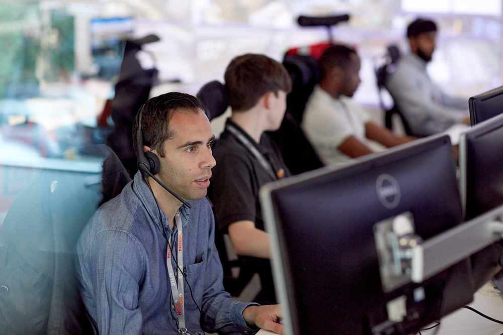 Man sitting at a computer with a headset on